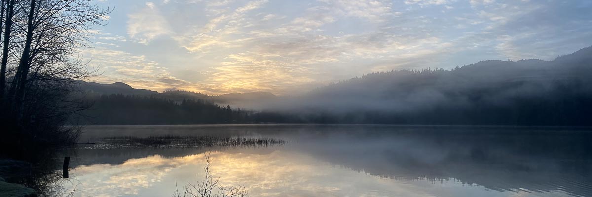 Sunrise over a small lake in wester washington, a popular spot for kayaking and running.